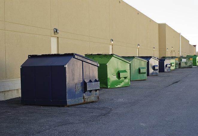 a group of dumpsters lined up along the street ready for use in a large-scale construction project in Monette